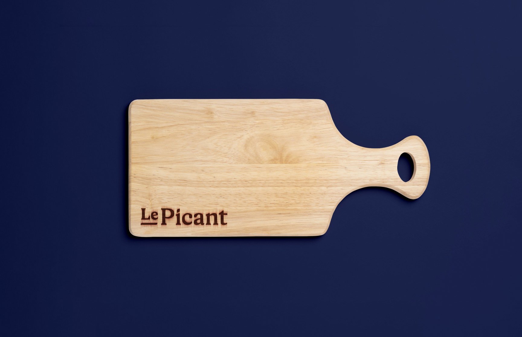 Holzbrett mit LePicant-Logo – minimalistisches Branddesign für Feinkostmarke, umgesetzt von der Agentur Neue Identität aus Bielefeld.